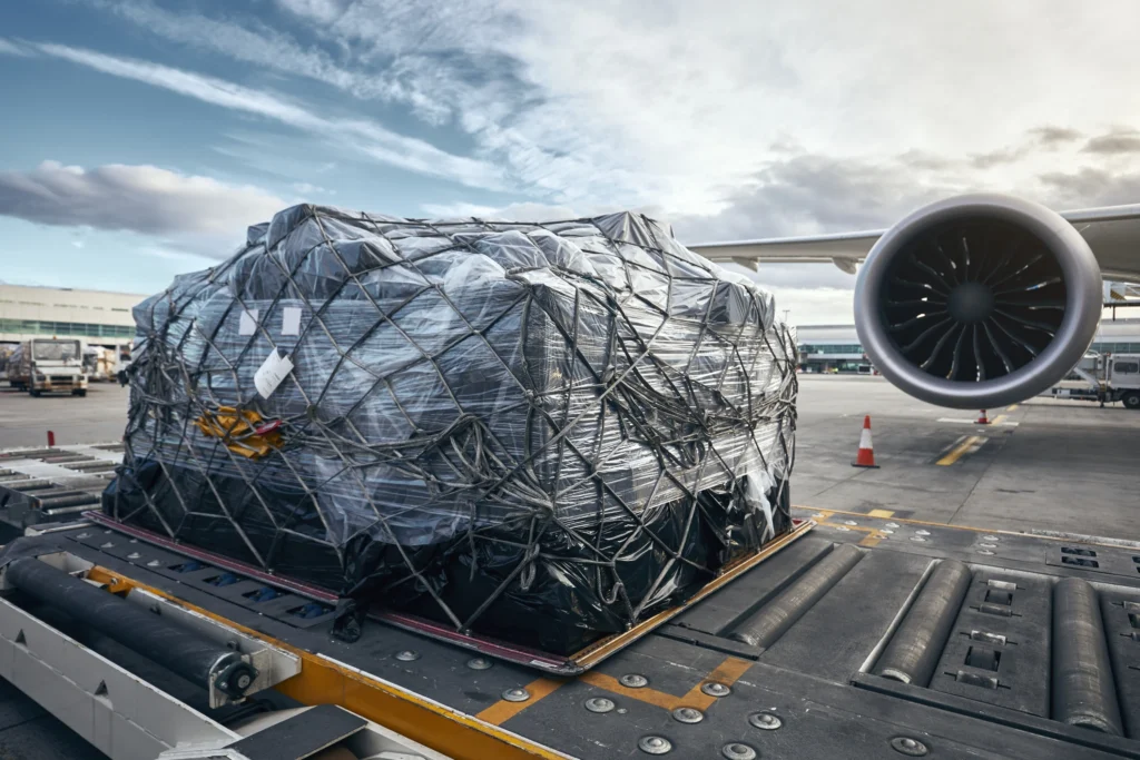 large plastic wrapped cargo object on airport tarmac